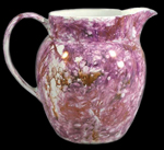 Jug approximately 4 inches tall, with impressed "Wedgewood" on bottom, decorated in pink luster on white body. Luster also includes orange and gray traces. - Private Collection